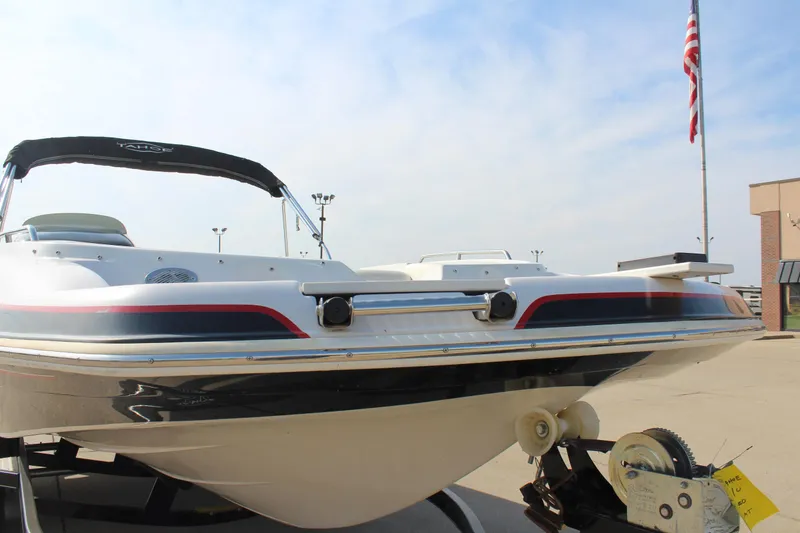 Slide: The Image of 2015 Tahoe 215 I/O boat on trailer, American flag in background. - 9