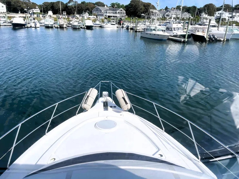 Slide: The Image of 2006 Silverton 39 Motor Yacht docked in a scenic marina. - 10
