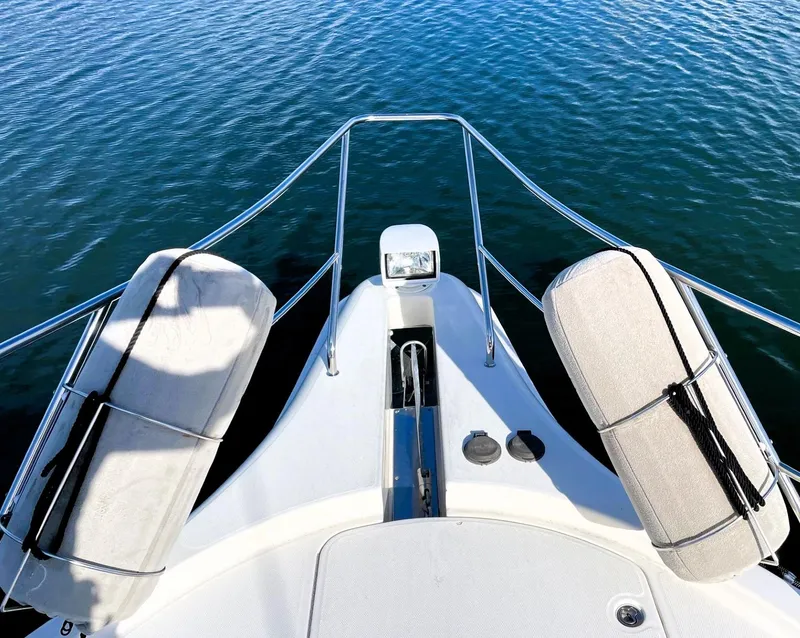 Slide: The Image of Bow view of 2006 Silverton 39 Motor Yacht on calm water. - 11