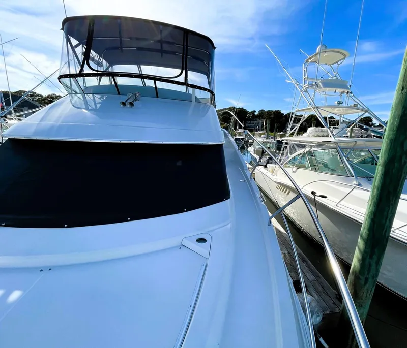 Slide: The Image of 2006 Silverton 39 Motor Yacht docked under clear blue sky. - 14