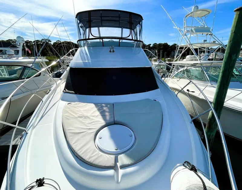 Slide: The Image of 2006 Silverton 39 Motor Yacht docked, showcasing sleek design and spacious deck. - 15