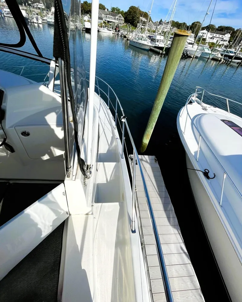 Slide: The Image of 2006 Silverton 39 Motor Yacht docked at a marina, surrounded by calm waters. - 17