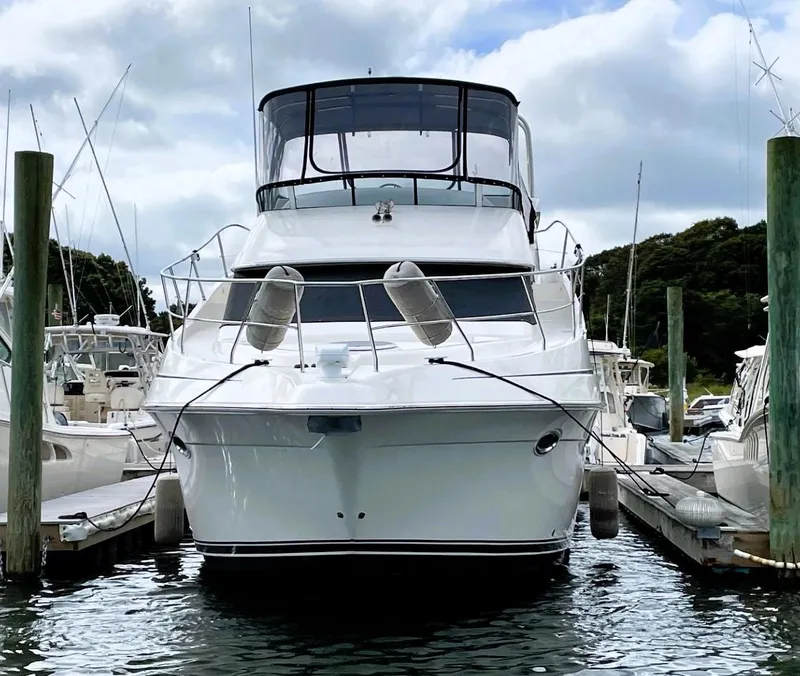 Slide: The Image of 2006 Silverton 39 Motor Yacht docked at marina under cloudy sky. - 2