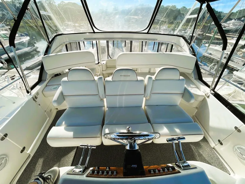 Slide: The Image of 2006 Silverton 39 Motor Yacht interior with white seating and helm, showcasing luxury design. - 23