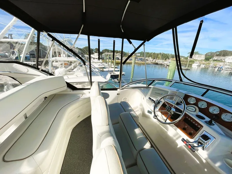 Slide: The Image of 2006 Silverton 39 Motor Yacht helm with panoramic marina view. - 24