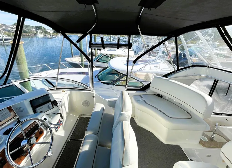 Slide: The Image of 2006 Silverton 39 Motor Yacht interior with helm, seating, and marina view. - 25