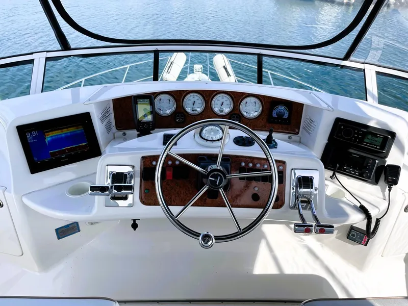Slide: The Image of Helm of 2006 Silverton 39 Motor Yacht with navigation instruments and steering wheel. - 26