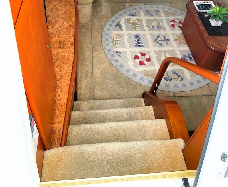 Slide: The Image of Interior stairs of 2006 Silverton 39 Motor Yacht with nautical-themed rug. - 29