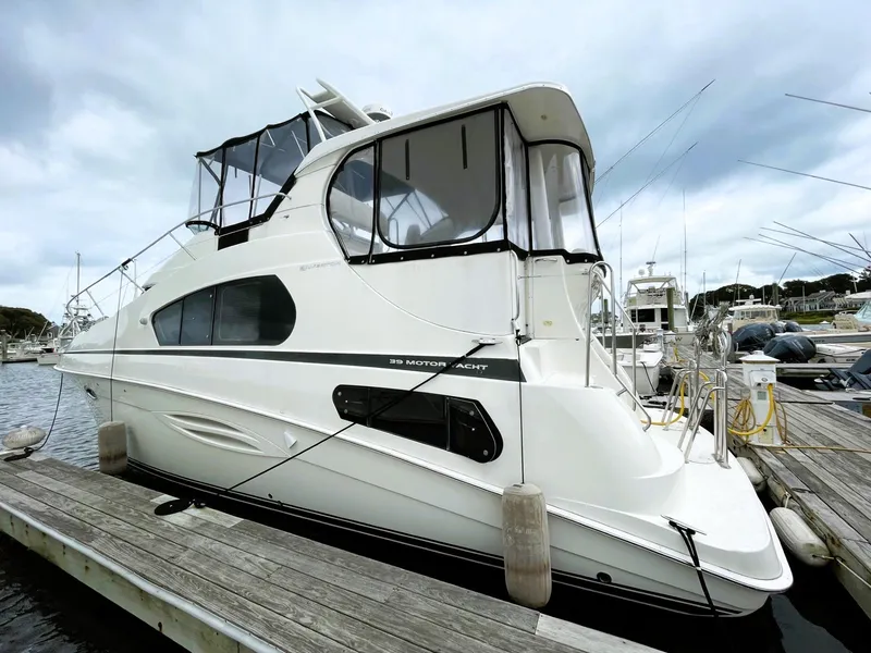Slide: The Image of 2006 Silverton 39 Motor Yacht docked at a marina under cloudy skies. - 3