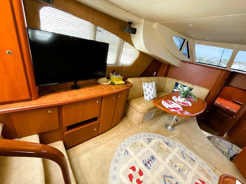 Slide: The Image of Luxurious interior of a 2006 Silverton 39 Motor Yacht with TV and cozy seating area. - 31