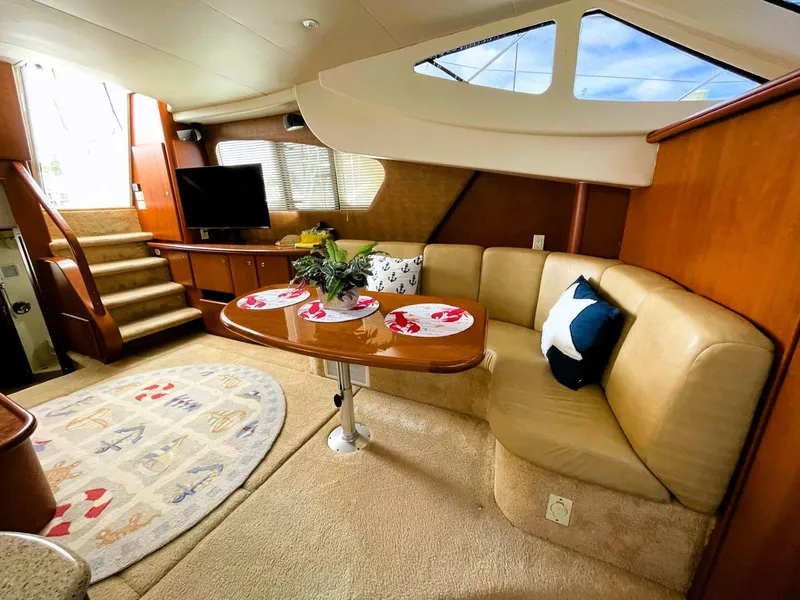Slide: The Image of Luxurious interior of 2006 Silverton 39 Motor Yacht with elegant dining area and cozy seating. - 32