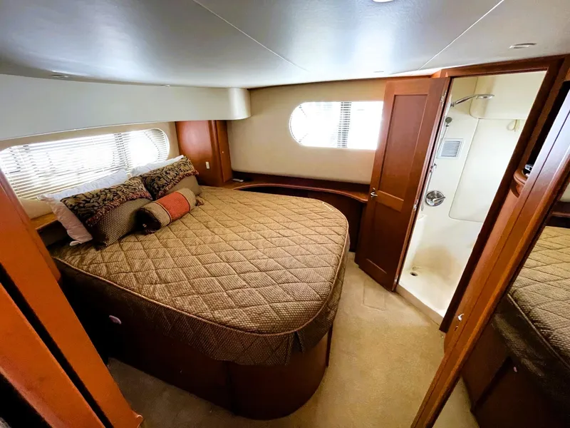 Slide: The Image of Luxurious bedroom in 2006 Silverton 39 Motor Yacht with cozy bed and ensuite bathroom. - 33