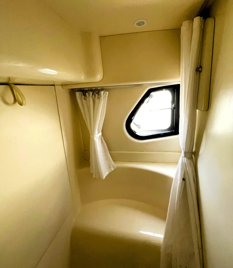 Slide: The Image of 2006 Silverton 39 Motor Yacht interior cabin with window and curtains. - 35