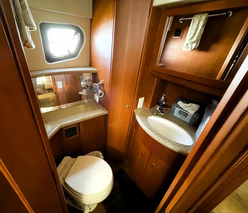 Slide: The Image of 2006 Silverton 39 Motor Yacht bathroom with sink, toilet, and window. - 36