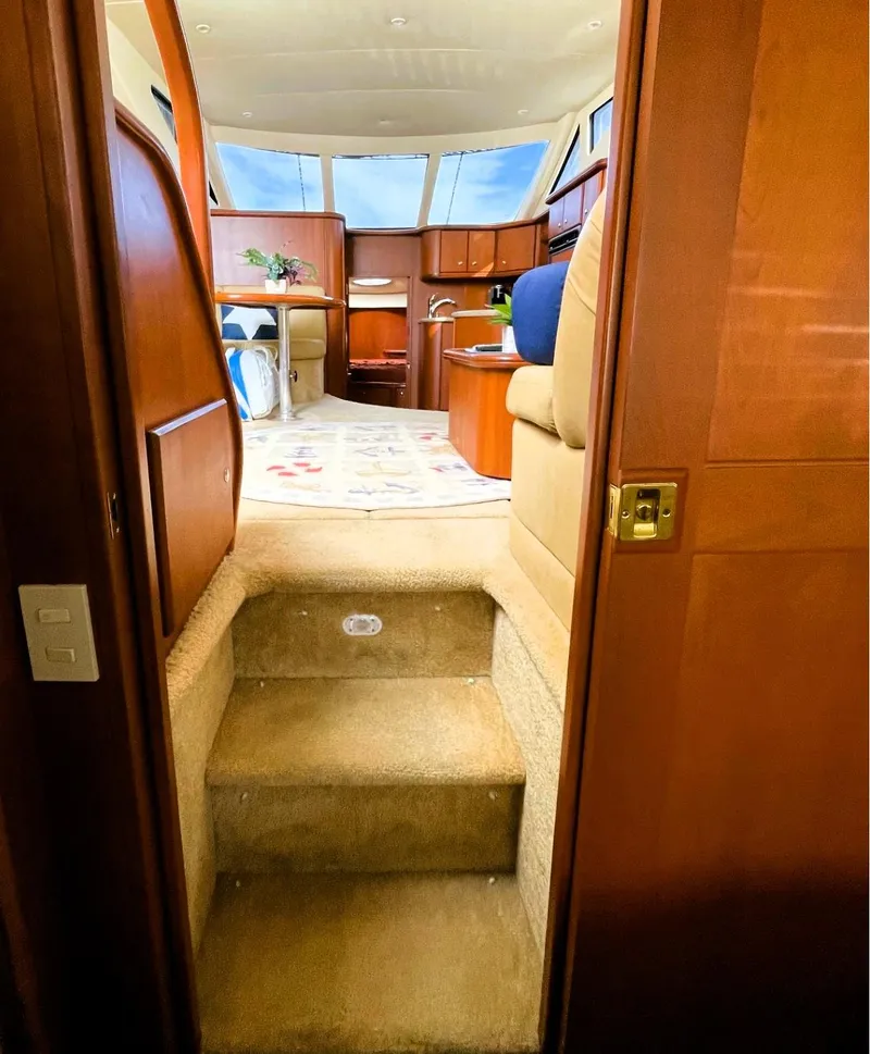 Slide: The Image of Interior view of 2006 Silverton 39 Motor Yacht with wooden finishes and carpeted stairs. - 40