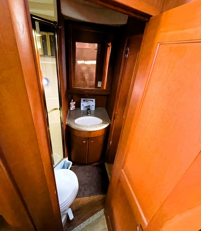Slide: The Image of 2006 Silverton 39 Motor Yacht bathroom with wood cabinetry and compact design. - 42