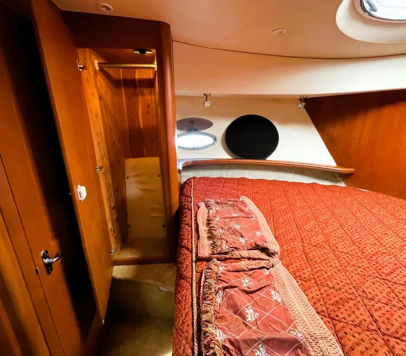 Slide: The Image of Luxurious cabin interior of 2006 Silverton 39 Motor Yacht with red bedding. - 44