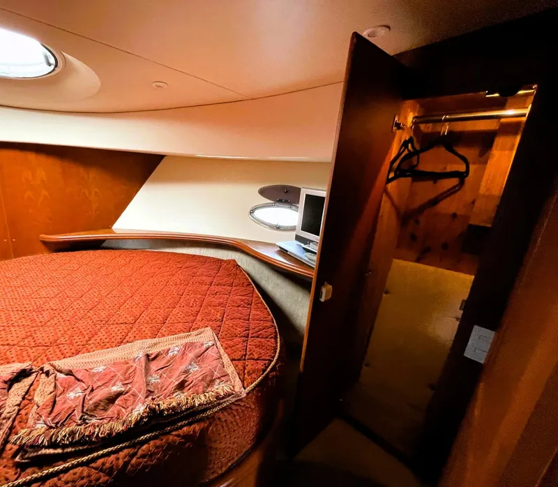 Slide: The Image of Luxurious bedroom interior of 2006 Silverton 39 Motor Yacht with cozy bedding and closet. - 45