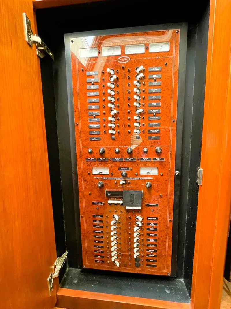 Slide: The Image of Electrical panel inside 2006 Silverton 39 Motor Yacht, featuring switches and circuit breakers. - 47