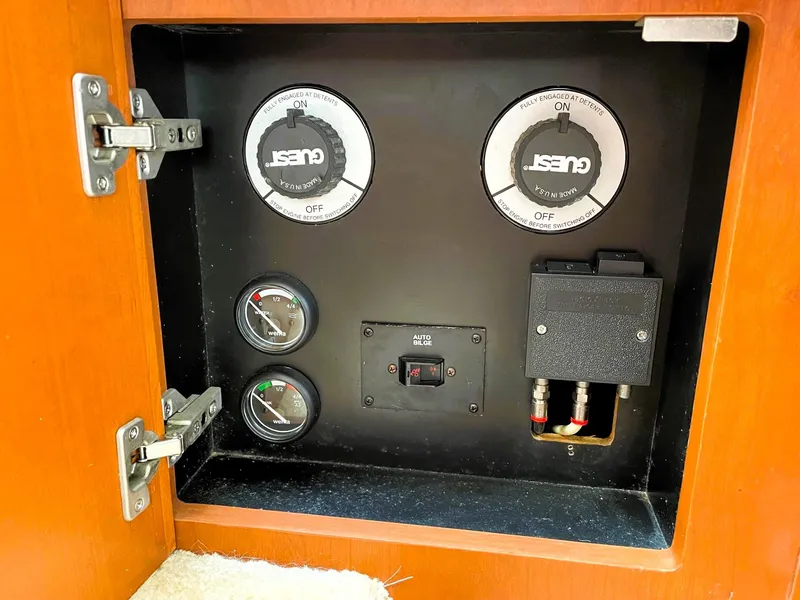 Slide: The Image of Control panel inside a 2006 Silverton 39 Motor Yacht, featuring gauges and switches. - 48