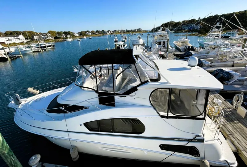 Slide: The Image of 2006 Silverton 39 Motor Yacht docked in a marina, featuring sleek design and spacious deck. - 5
