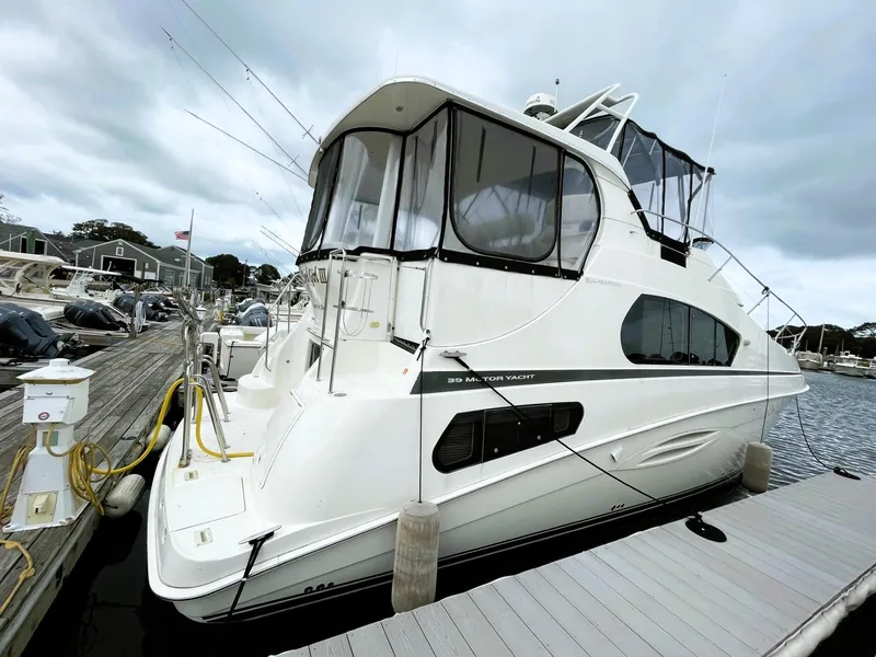 Slide: The Image of 2006 Silverton 39 Motor Yacht docked at marina under cloudy skies. - 6