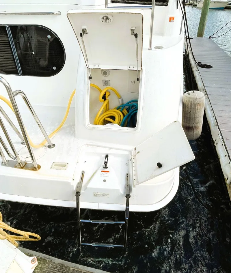 Slide: The Image of 2006 Silverton 39 Motor Yacht with open storage compartment and dockside view. - 8