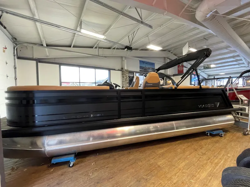 The Image of 2025 Viaggio Lago Z22U pontoon boat displayed indoors, featuring sleek black design. - 0