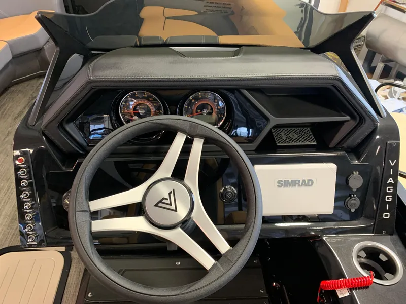 Slide: The Image of 2025 Viaggio Lago Z22U dashboard with steering wheel and Simrad display. - 4