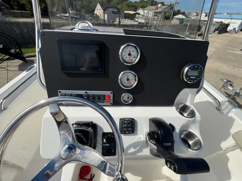 Slide: The Image of 2025 Key West 189 FS boat dashboard with steering wheel and gauges. - 10