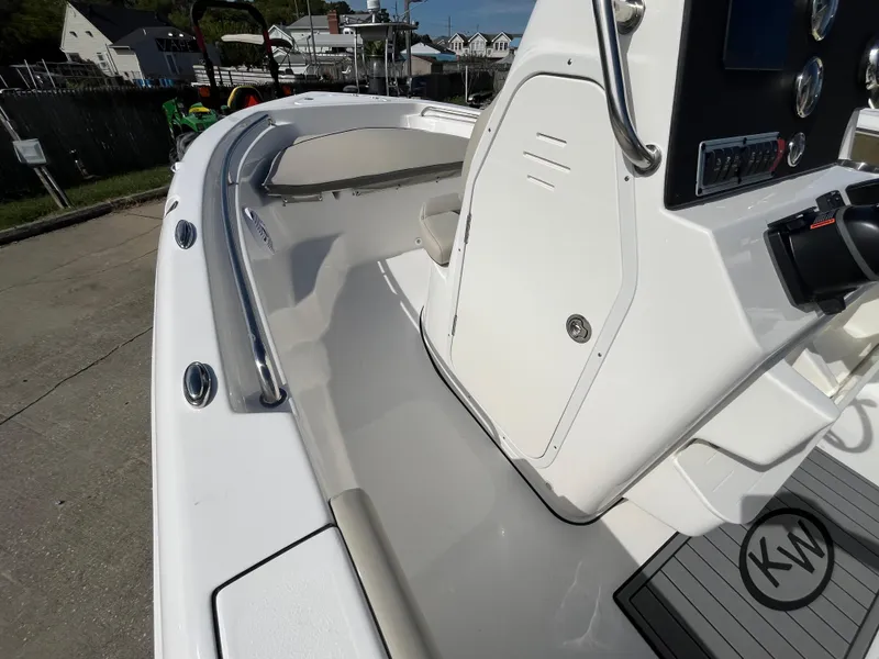 Slide: The Image of 2025 Key West 189 FS boat interior with console and seating, docked outdoors. - 11
