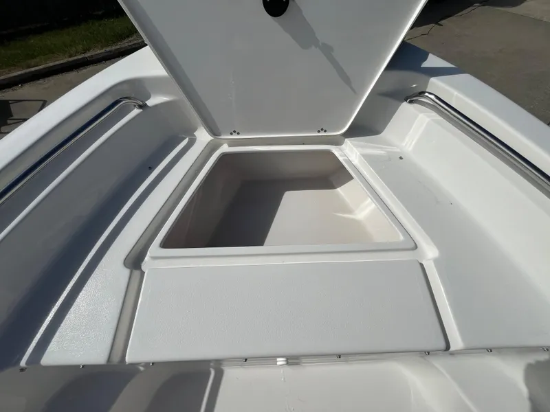 Slide: The Image of 2025 Key West 189 FS boat storage compartment, open lid, white interior. - 16