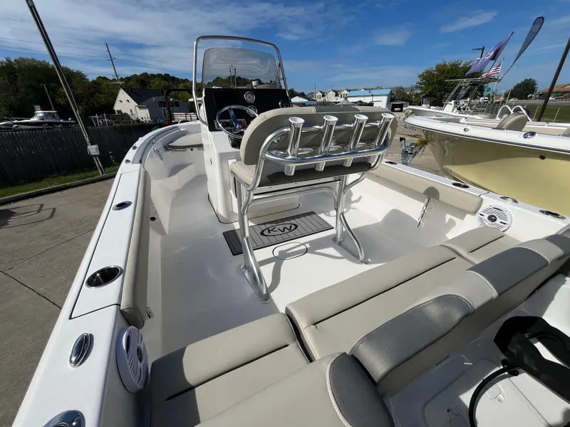 Slide: The Image of 2025 Key West 189 FS boat interior with seating and console, docked outdoors. - 4