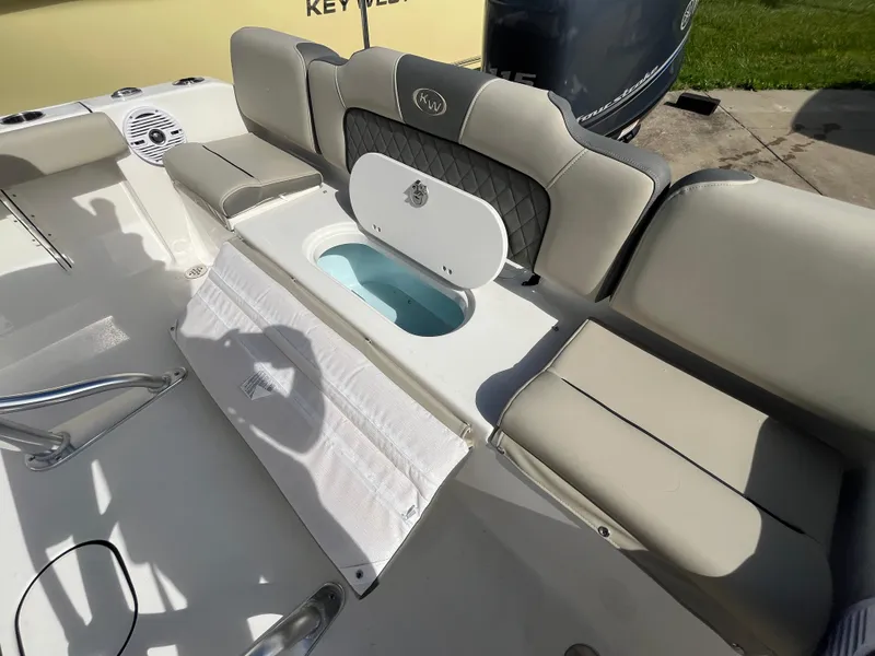 Slide: The Image of 2025 Key West 189 FS boat interior with cushioned seating and storage compartment. - 6