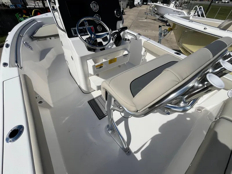 Slide: The Image of 2025 Key West 189 FS boat interior with steering console and seating. - 7