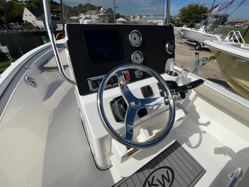 Slide: The Image of 2025 Key West 189 FS boat dashboard with steering wheel and gauges. - 9