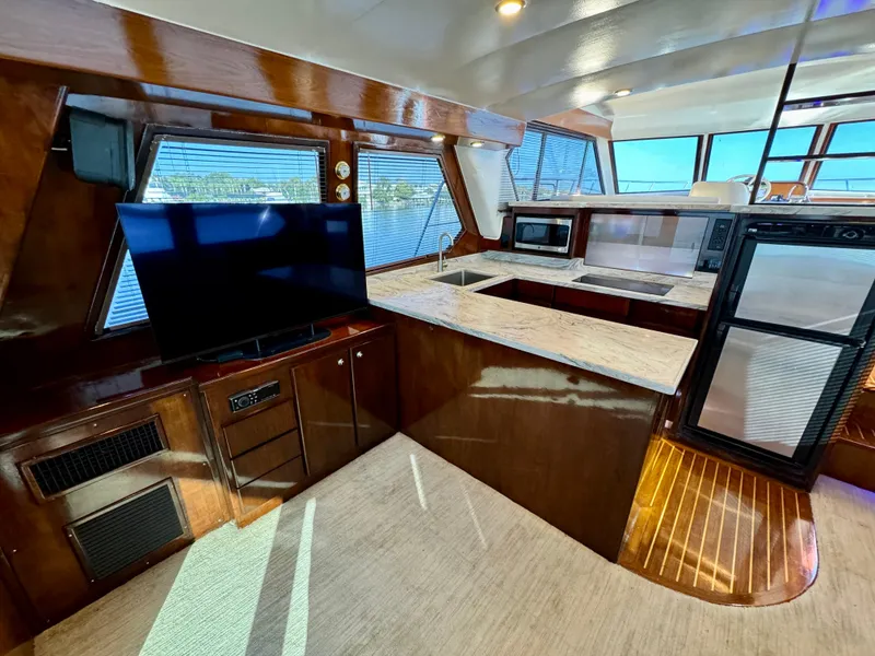 Slide: The Image of Luxurious 1998 Navigator Pilothouse yacht interior with modern kitchen and entertainment area. - 19