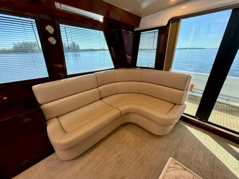 Slide: The Image of Luxurious 1998 Navigator Pilothouse interior with beige leather seating and scenic water view. - 20