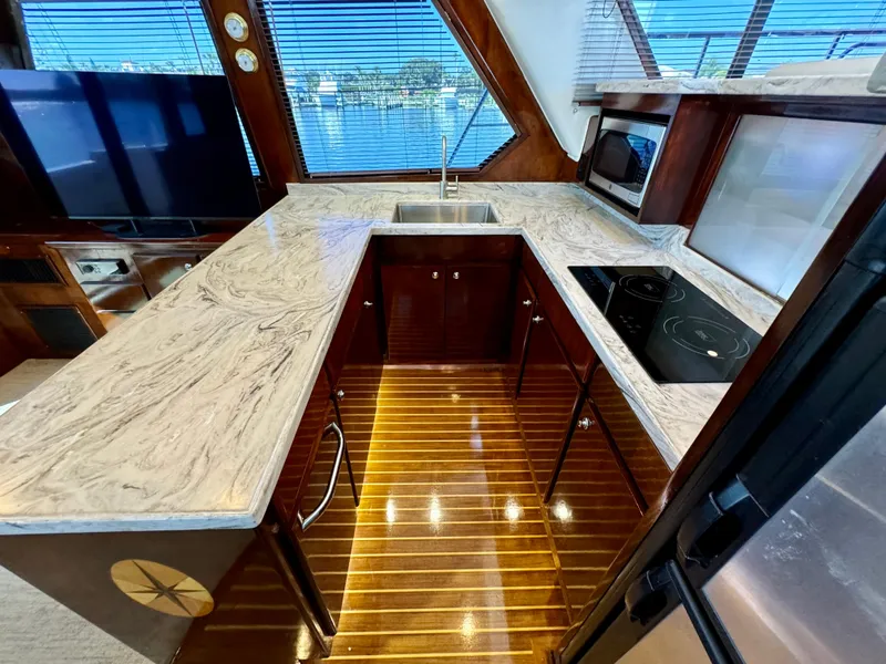 Slide: The Image of Luxurious 1998 Navigator Pilothouse kitchen with marble countertops and modern appliances. - 23