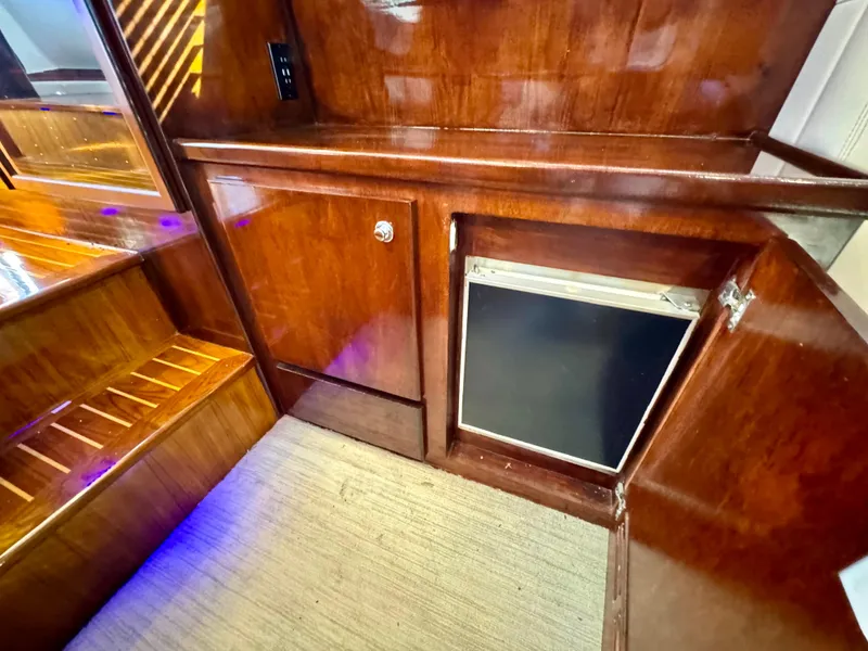 Slide: The Image of 1998 Navigator Pilothouse interior with polished wood cabinetry and mini fridge. - 29