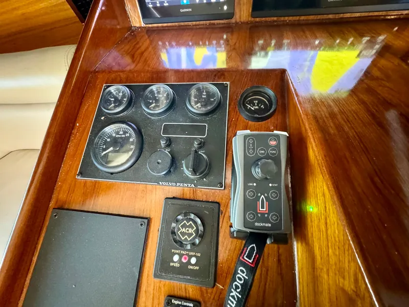 Slide: The Image of 1998 Navigator Pilothouse control panel with gauges and joystick on wooden dashboard. - 36