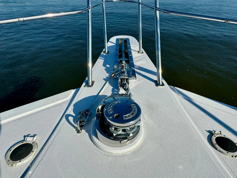 Slide: The Image of 1998 Navigator Pilothouse boat deck with anchor and railing on calm water. - 43