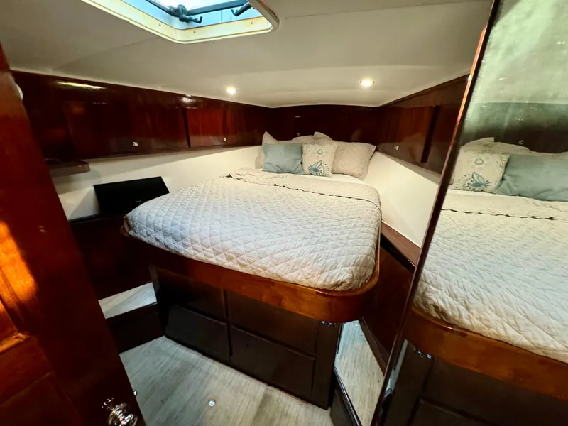 Slide: The Image of Cozy bedroom in 1998 Navigator Pilothouse yacht with wood paneling and skylight. - 44