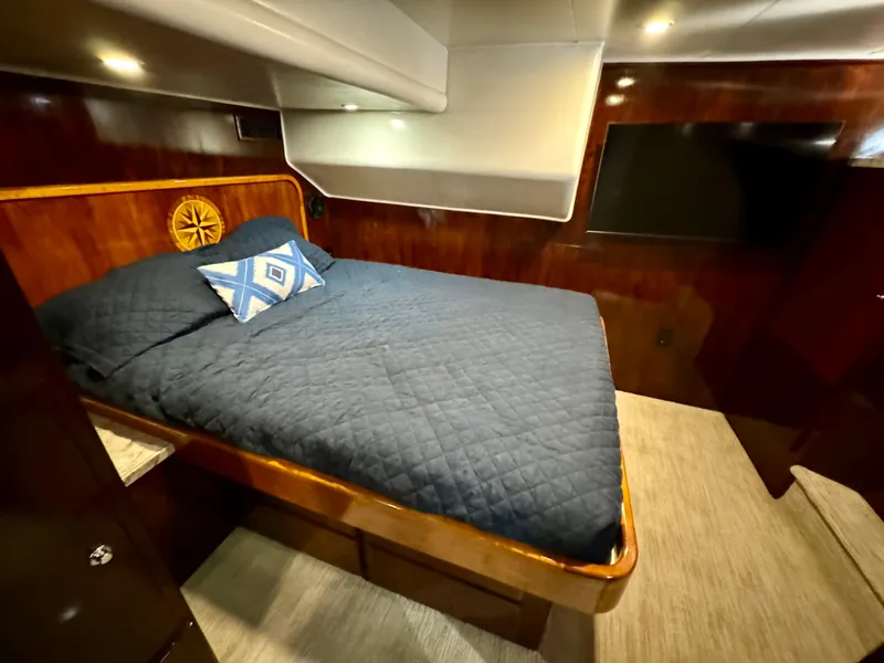 Slide: The Image of Luxurious 1998 Navigator Pilothouse bedroom with wood paneling and cozy bedding. - 48