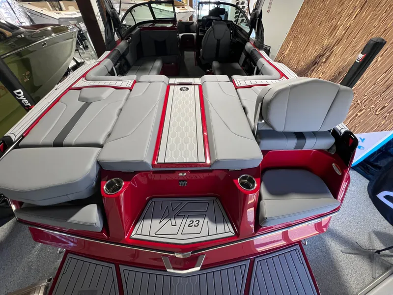 Slide: The Image of 2024 MasterCraft XT23 boat interior with red and gray seating and modern design. - 5