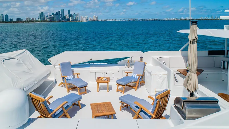 Slide: The Image of Luxurious 1998 Burger Raised Pilothouse yacht deck with seating, ocean view, and city skyline. - 15