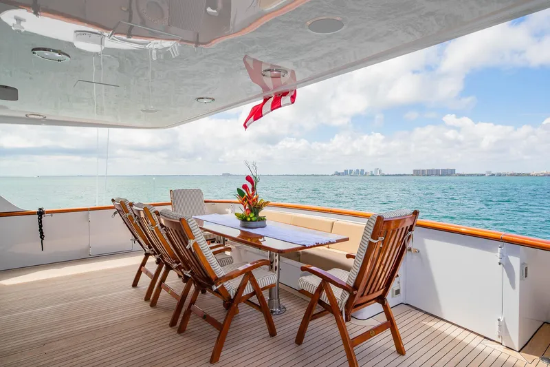 Slide: The Image of Luxurious 1998 Burger Raised Pilothouse yacht deck with ocean view and dining area. - 24