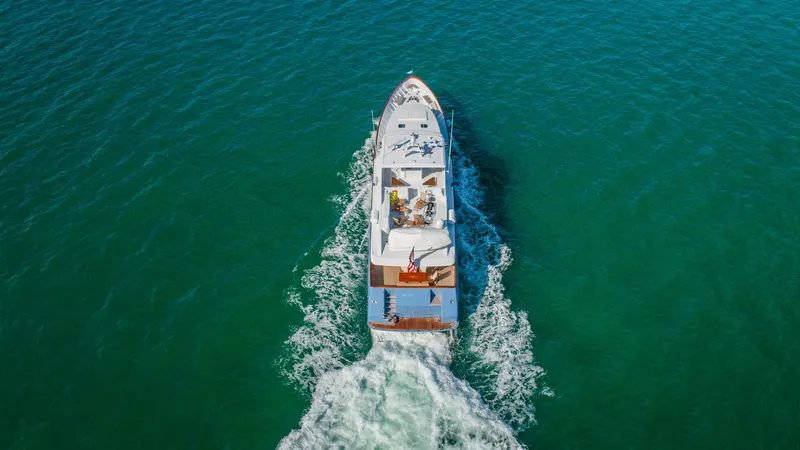 Slide: The Image of Aerial view of 1998 Burger Raised Pilothouse yacht cruising on open water. - 4