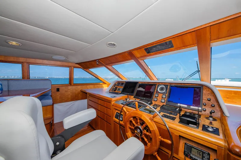 Slide: The Image of Luxurious 1998 Burger Raised Pilothouse yacht interior with wooden helm and modern navigation equipment. - 41