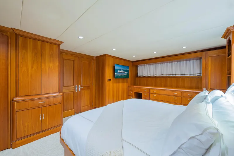 Slide: The Image of Luxurious 1998 Burger Raised Pilothouse yacht bedroom with elegant wood paneling and cozy bedding. - 45